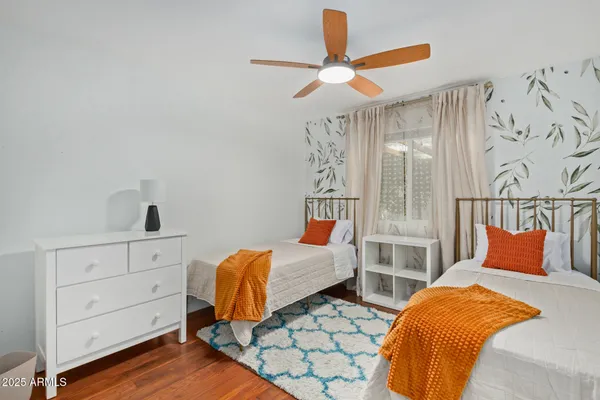 a bed room with a bed and a ceiling fan