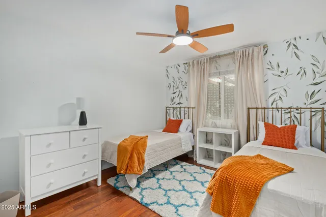 a bed room with a bed and a ceiling fan