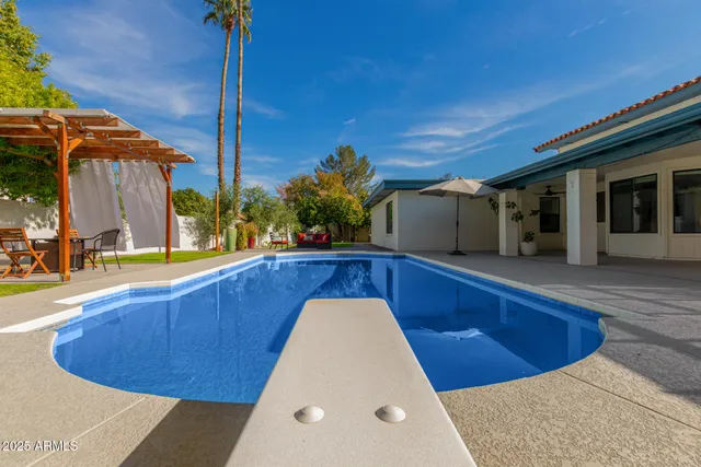 a view of a swimming pool with outdoor seating