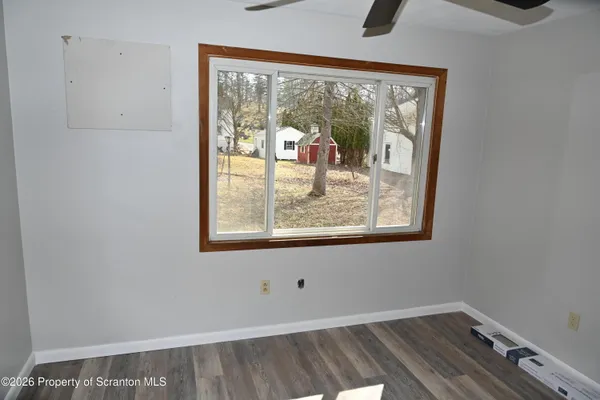 a view of a room with wooden floor and windows