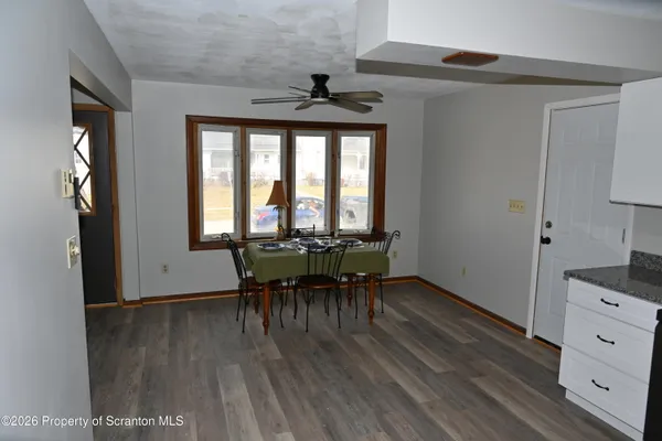 a dining room with furniture and wooden floor