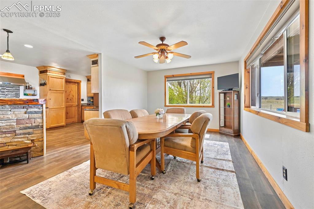 18560 Chelton Road Ramah, CO 80832 - Photo 8 of 34 a dining room with furniture a chandelier and wooden floor
