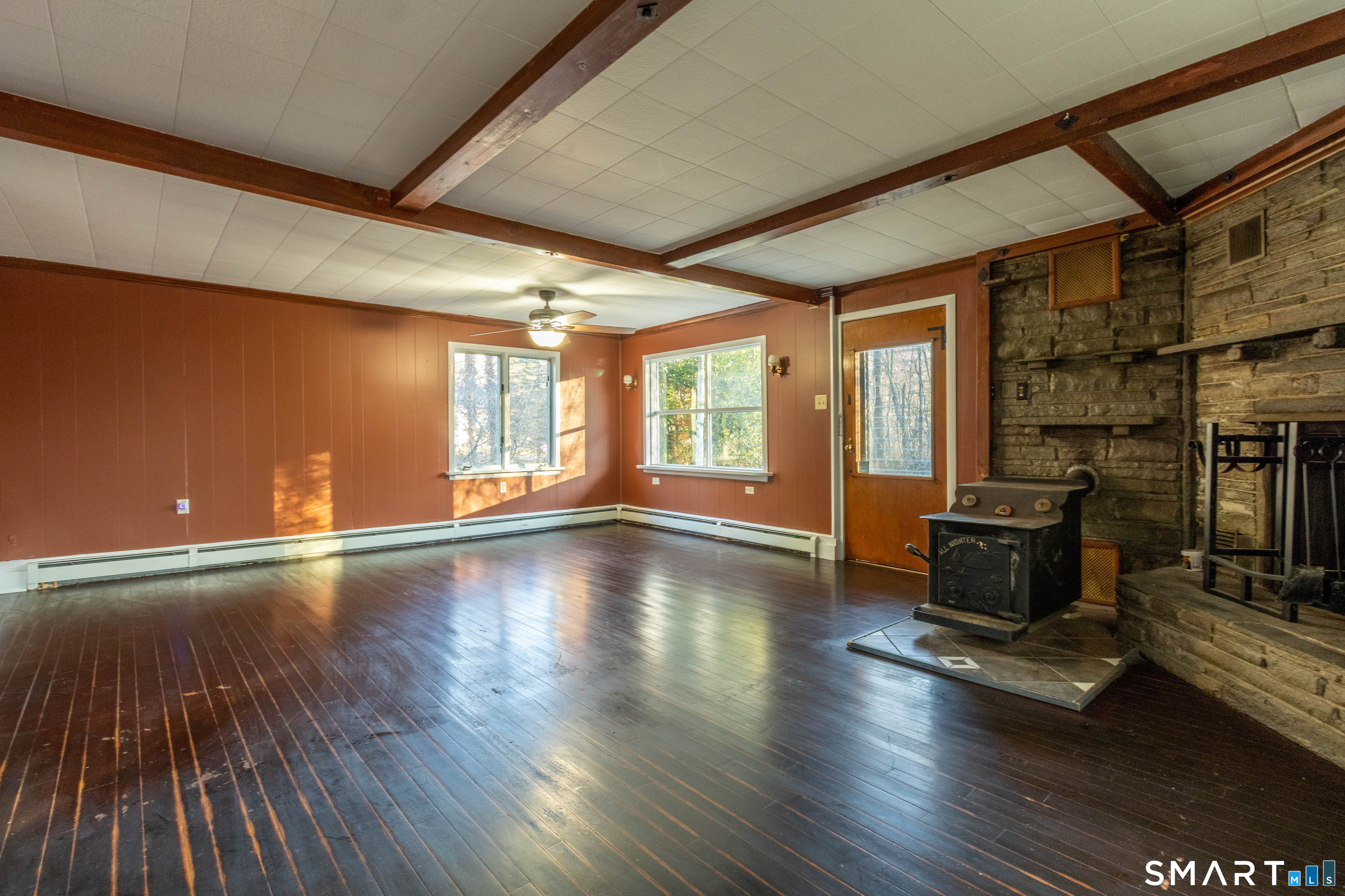 1661 Center Groton Road Ledyard, CT 06339 - Photo 12 of 39 a living room with hard wood floors and a fireplace