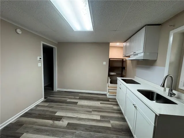 a kitchen with stainless steel appliances a sink a stove a refrigerator and cabinets