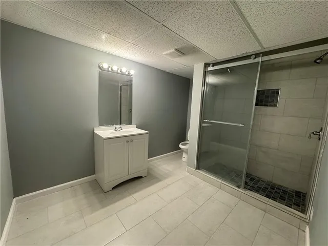 a bathroom with a sink mirror and shower