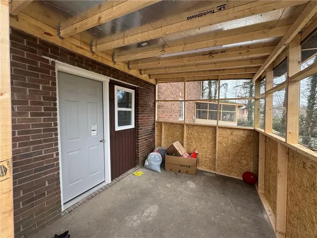 a view of a room with wooden floor and windows