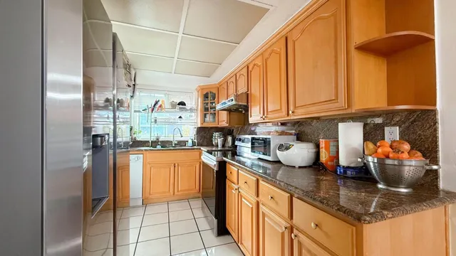 a kitchen with stainless steel appliances granite countertop a sink and cabinets