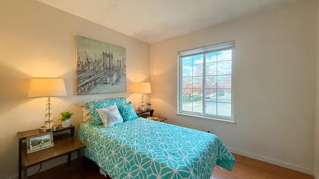 a bedroom with a bed and a window