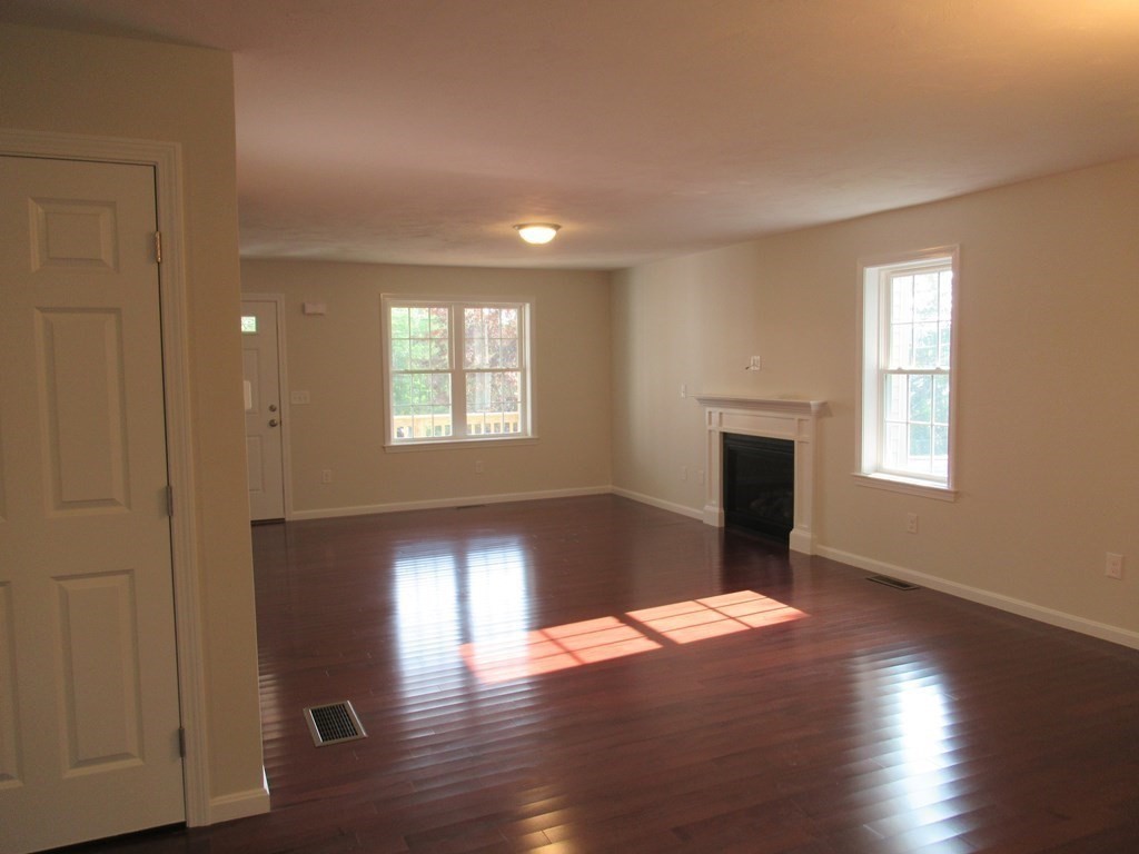 16 Farnum Street Uxbridge, MA 01569 - Photo 14 of 27 a view of an empty room with wooden floor and a window