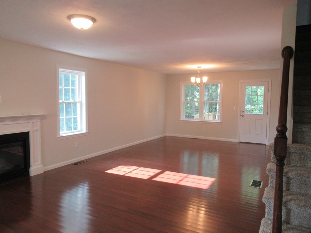16 Farnum Street Uxbridge, MA 01569 - Photo 15 of 27 an empty room with wooden floor and windows