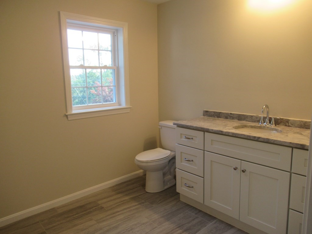 16 Farnum Street Uxbridge, MA 01569 - Photo 18 of 27 a bathroom with a granite countertop toilet and sink