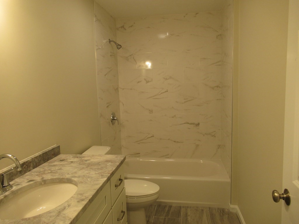 16 Farnum Street Uxbridge, MA 01569 - Photo 21 of 27 a bathroom with a granite countertop sink toilet and shower