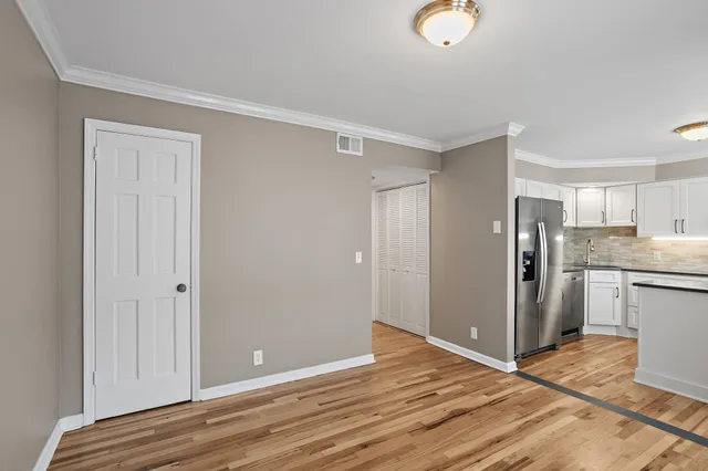 a view of kitchen with a sink refrigerator and wooden floor