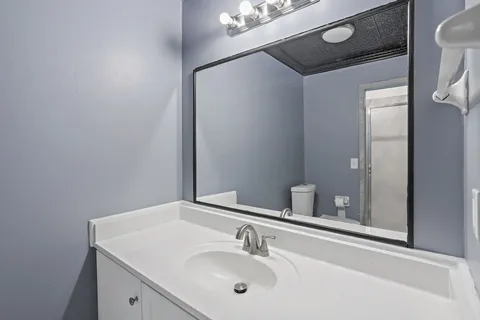 a bathroom with a sink and a mirror