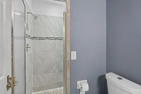 a bathroom with a shower and toilet