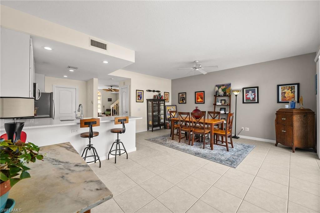 6072 Towncenter Circle Naples, FL 34119 - Photo 14 of 45 a group of people sitting in a living room