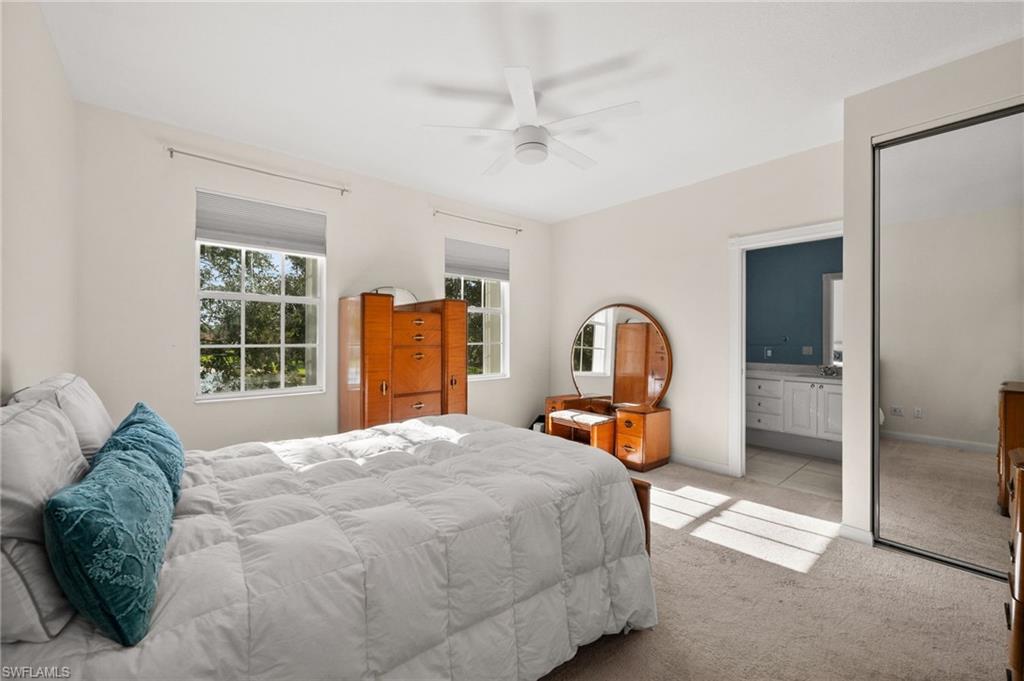 6072 Towncenter Circle Naples, FL 34119 - Photo 25 of 45 a bedroom with a bed and a large window
