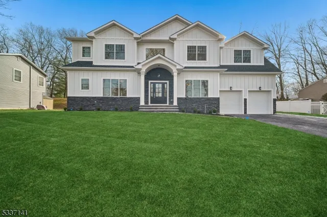 a view of a house with a big yard and large trees