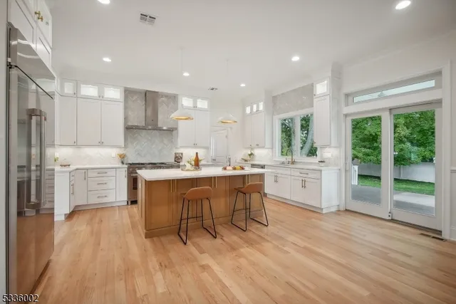 a kitchen with a sink cabinets and wooden floor