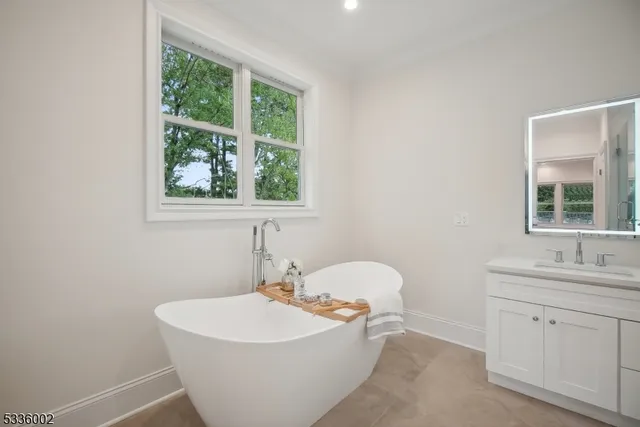 a white bath tub sitting next to a white sink