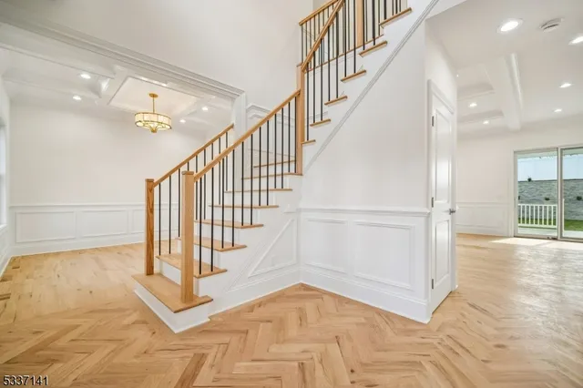 a view of staircase with white walls and a rug