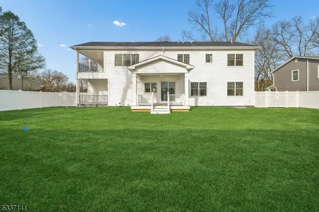 a front view of a house with a garden and yard