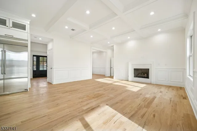 a view of an empty room with closet and a fireplace