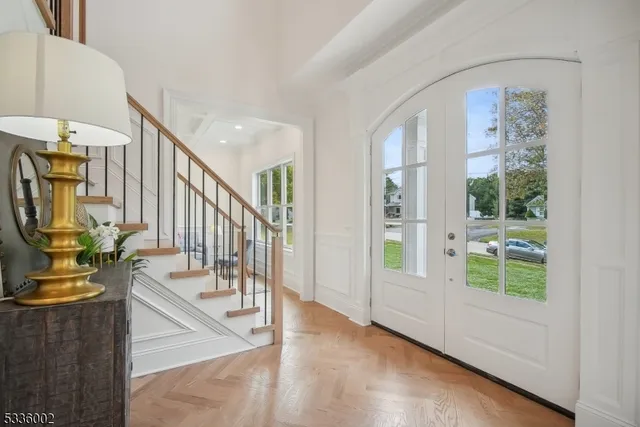 a view of an entryway with wooden floor and windows