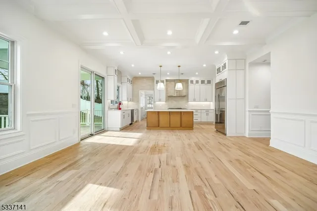 a big room with wooden floor and windows