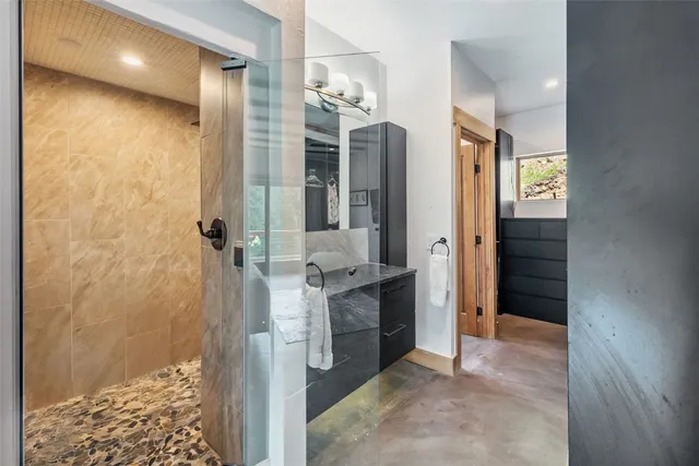 a bathroom with a double vanity sink toilet and shower