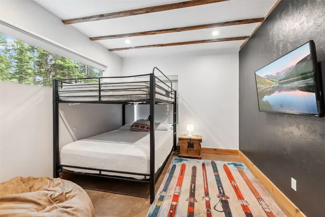 a bedroom with a bed and a chandelier