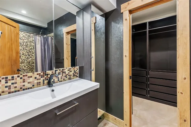 a bathroom with a double vanity sink and a mirror