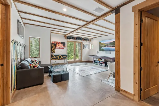 a living room with furniture and a chandelier