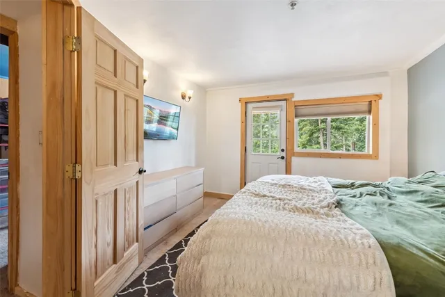 a spacious bedroom with a bed and a window