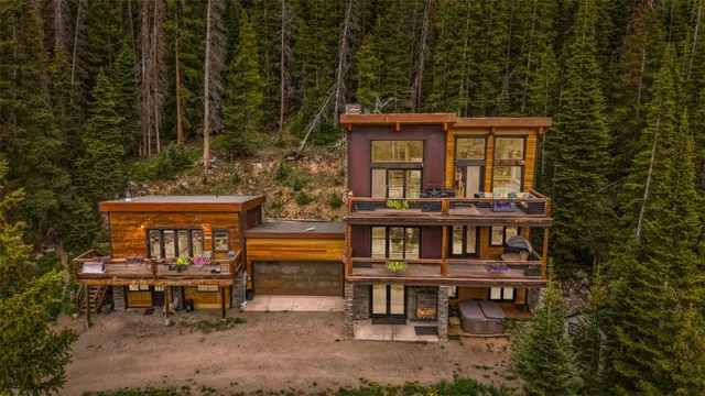 an outdoor sitting area with furniture and wooden floor