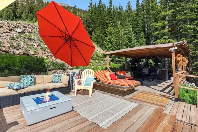 a living room with furniture a large window and a chandelier