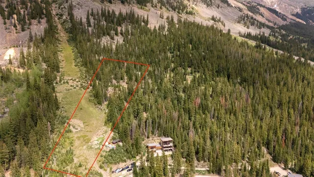 a view of a lush green hillside and mountains