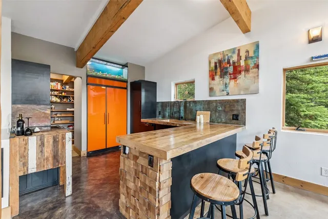 a dining room with furniture and a kitchen view