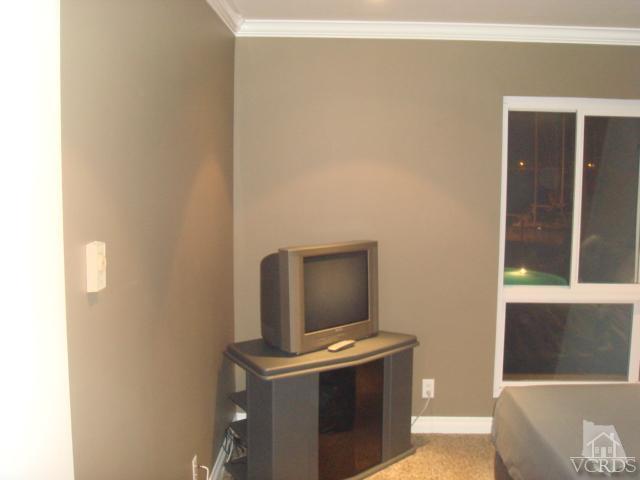 2901 Peninsula Road, Unit 247 Oxnard, CA 93035 - Photo 14 of 30 a living room with a couch and a table