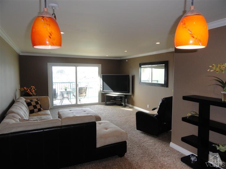 2901 Peninsula Road, Unit 247 Oxnard, CA 93035 - Photo 9 of 30 a living room with furniture flat screen tv and a fireplace