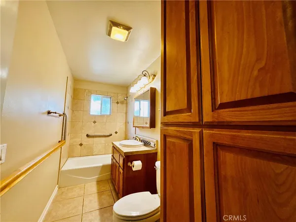 a bathroom with a toilet a sink and bathtub