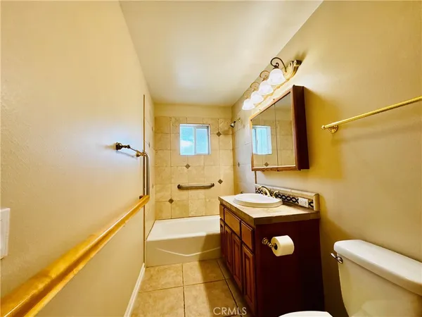 a bathroom with a sink toilet vanity and shower
