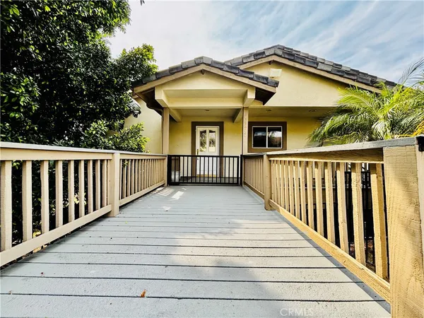 a view of a house with a wooden deck