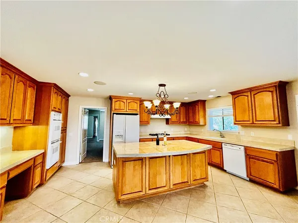a kitchen with a stove a sink and a refrigerator