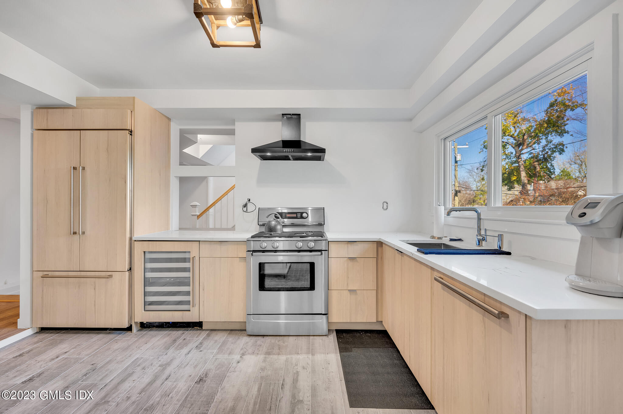 12 Taylor Drive Cos Cob, CT 06807 - Photo 8 of 21 a kitchen with stainless steel appliances a stove a sink and a refrigerator