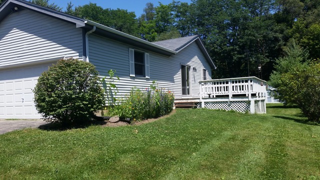 5N235 Hanson Road St. Charles, IL 60175 - Photo 11 of 17 a white house that has a small yard and large trees