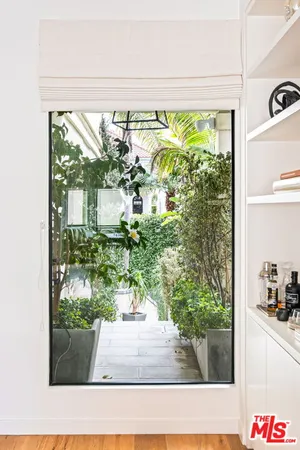 a kitchen with stainless steel appliances granite countertop a refrigerator a stove and white cabinets with wooden floor