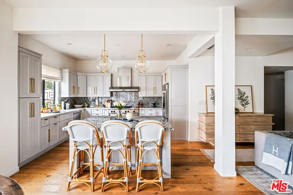 a kitchen with a stove a sink and a refrigerator