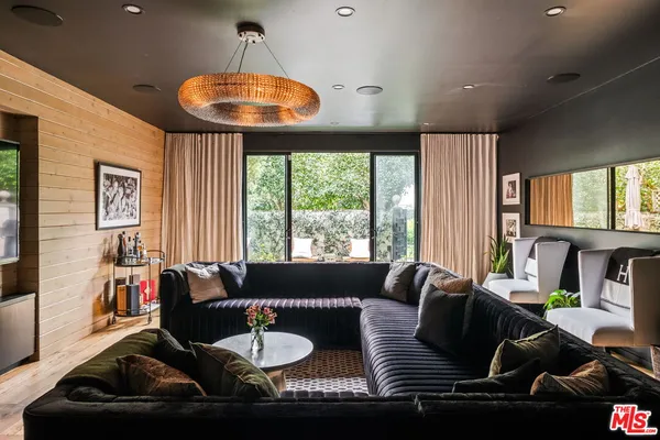 a living room with fireplace furniture and a floor to ceiling window