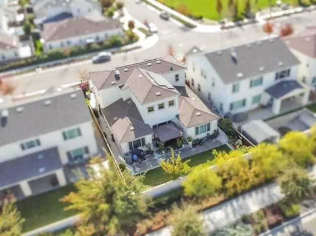 an aerial view of residential houses with yard